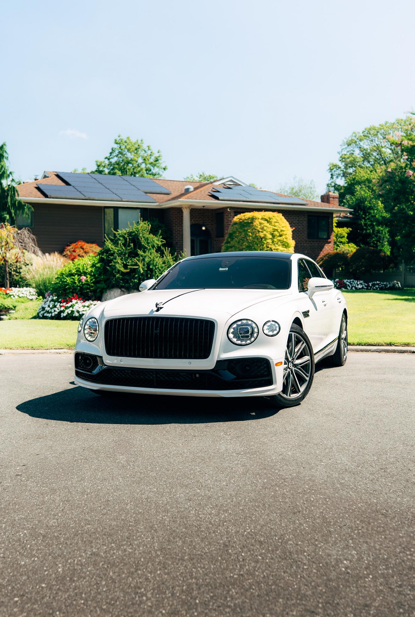 White Bentley Flying Spur shown from the front three-quarter angle
