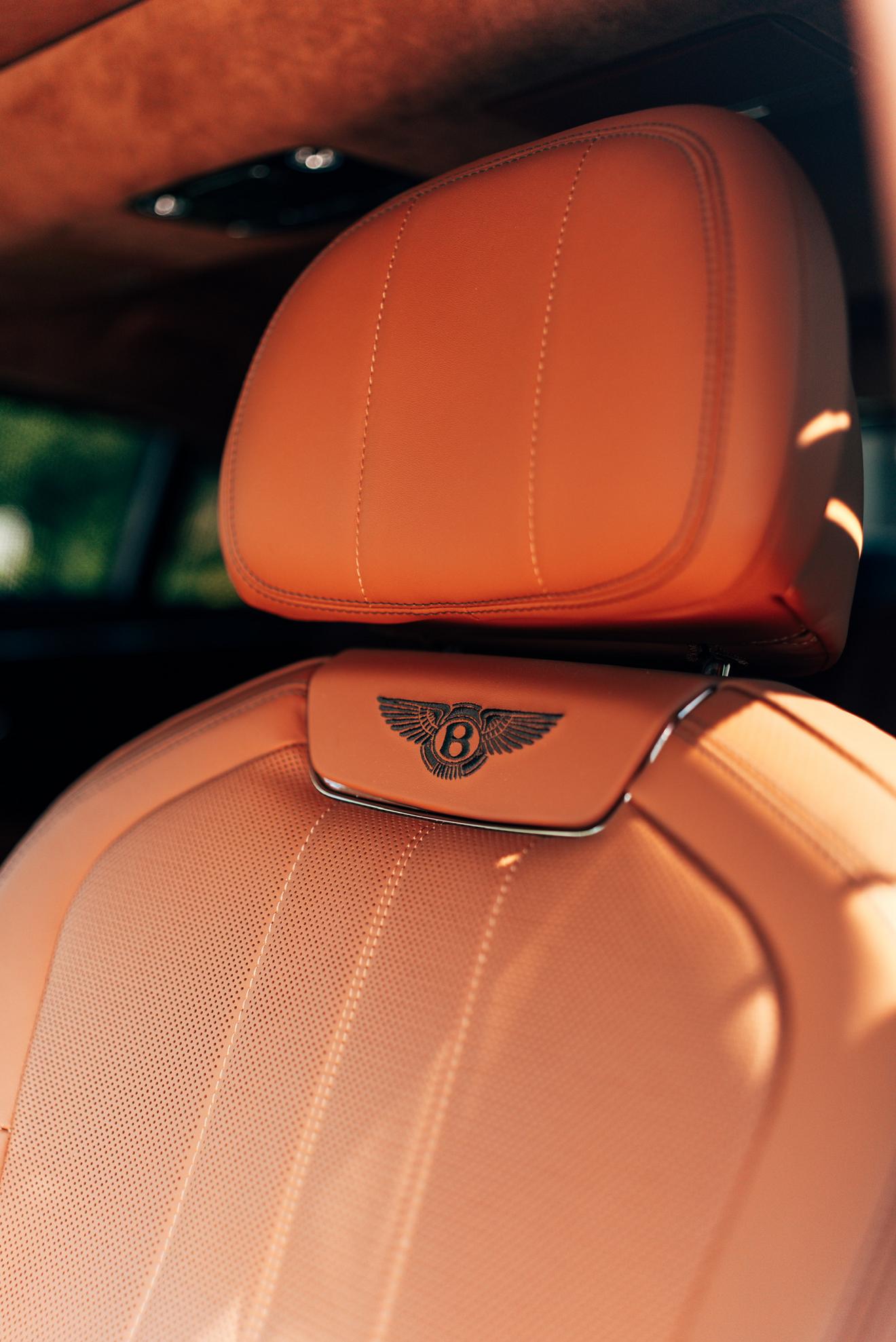 Tan leather seat with embroidered Bentley crest in the Bentley Flying Spur