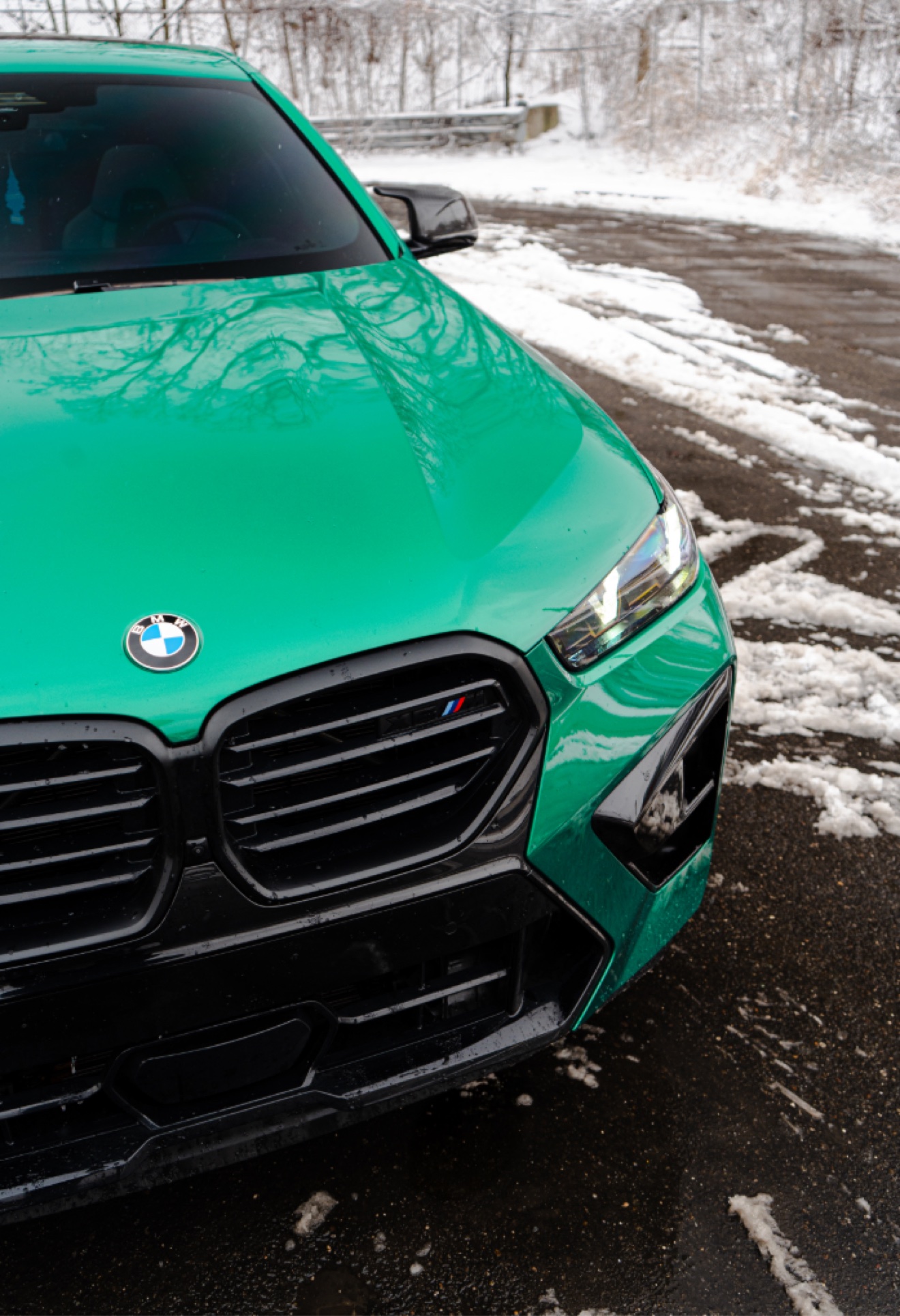Close-up front view of the green 2025 BMW X6 M Competition