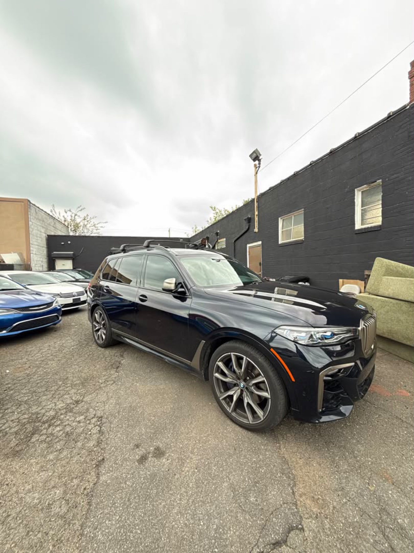 Black BMW X7 M50i shown from the front three-quarter angle
