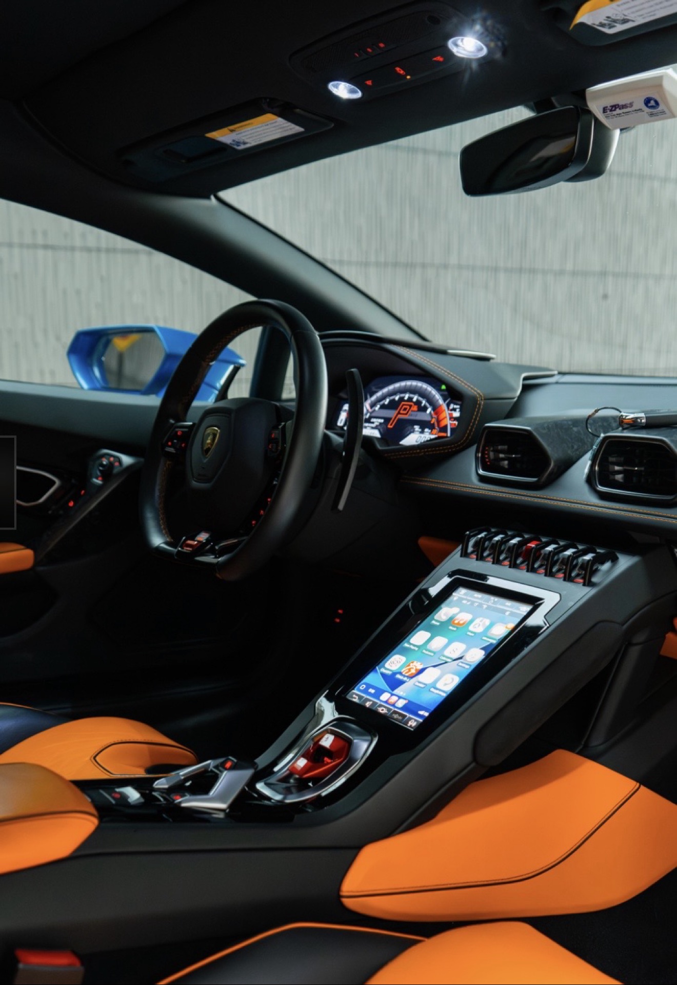 Dashboard and center console of the Lamborghini Huracán Evo with orange and black interior