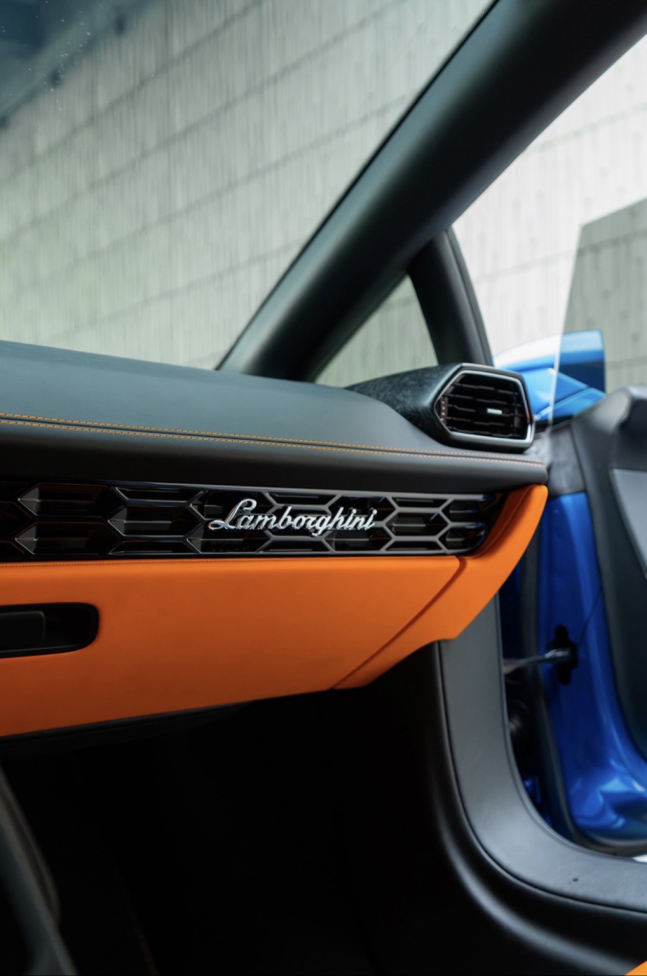 Orange and black passenger door detail in the Lamborghini Huracán Evo