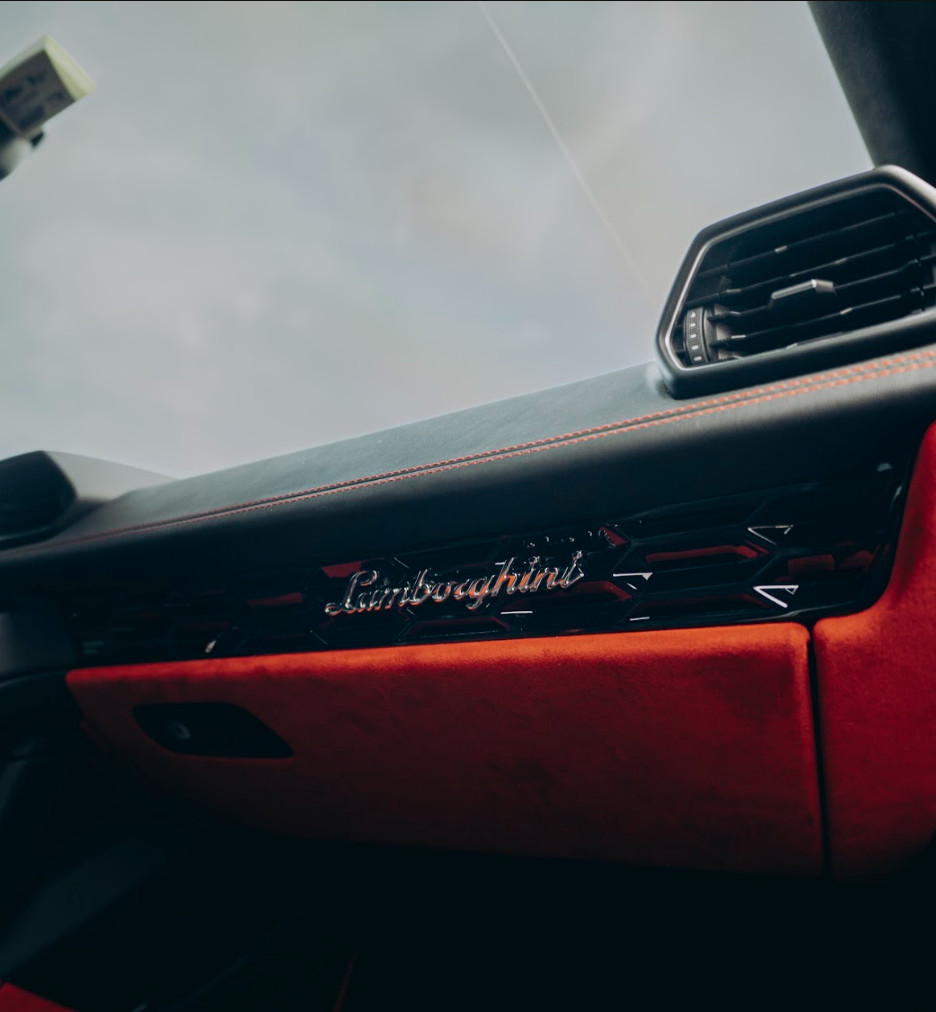 Lamborghini script detail on the dashboard of the red Lamborghini Huracán Evo