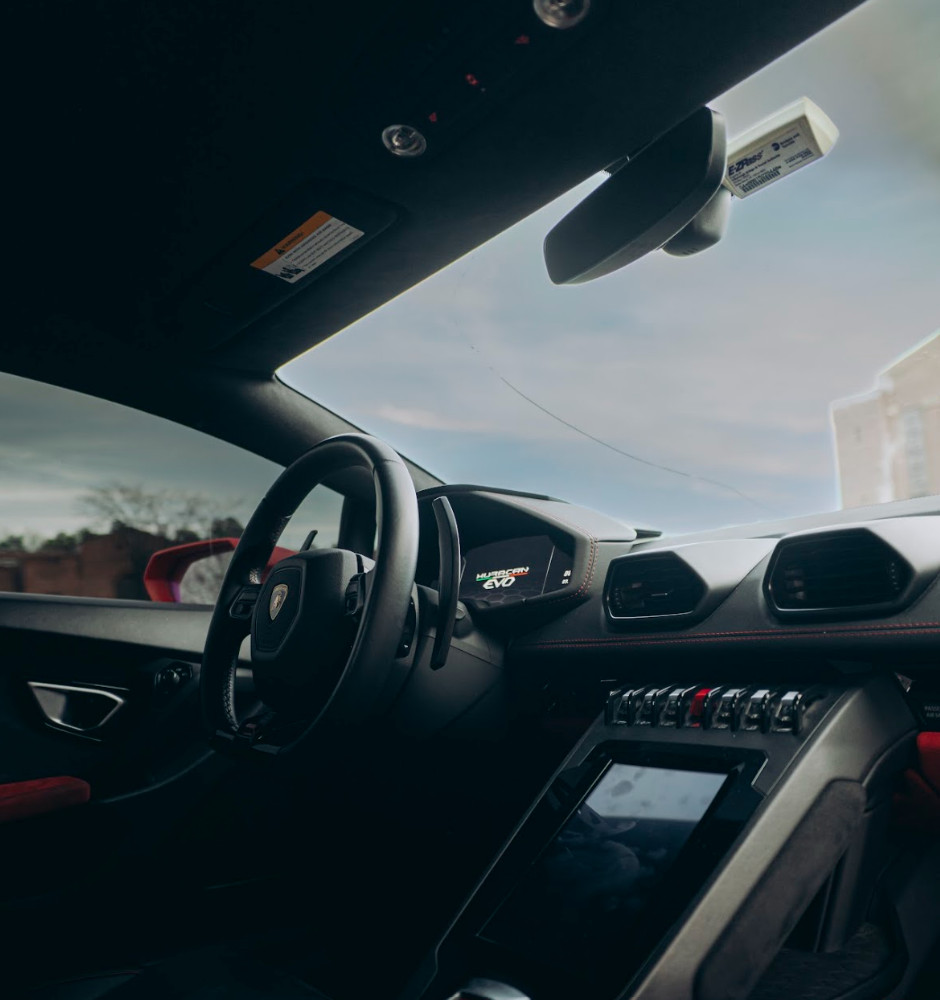 Dashboard and center console of the red Lamborghini Huracán Evo with red and black interior