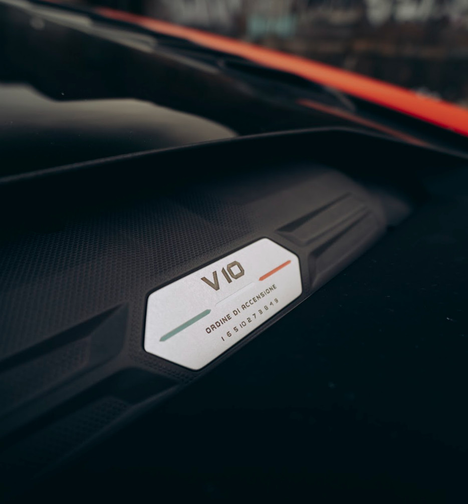 V10 engine plaque detail in the red Lamborghini Huracán Evo