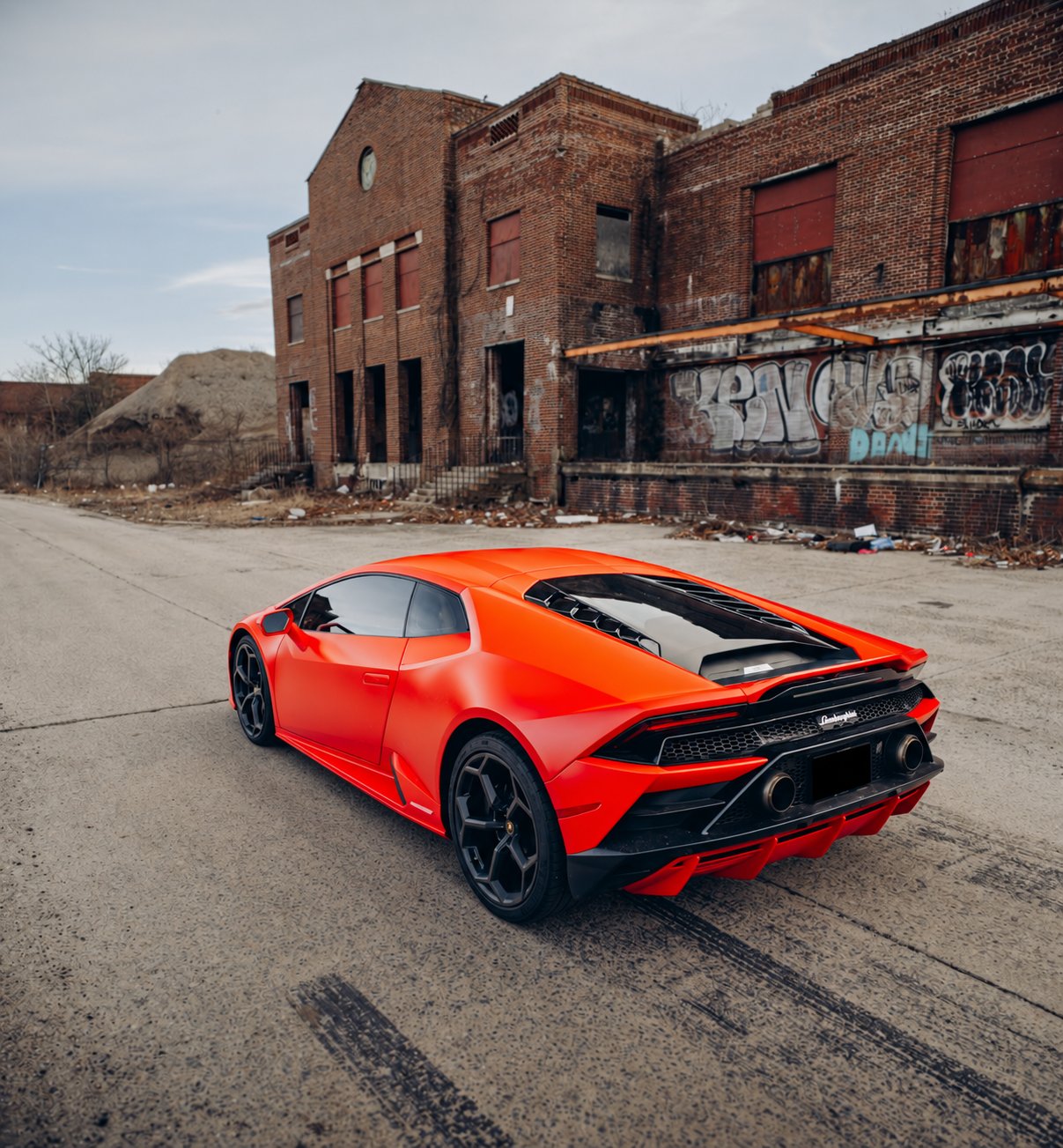 Red Lamborghini Huracán Evo shown from the rear three-quarter angle