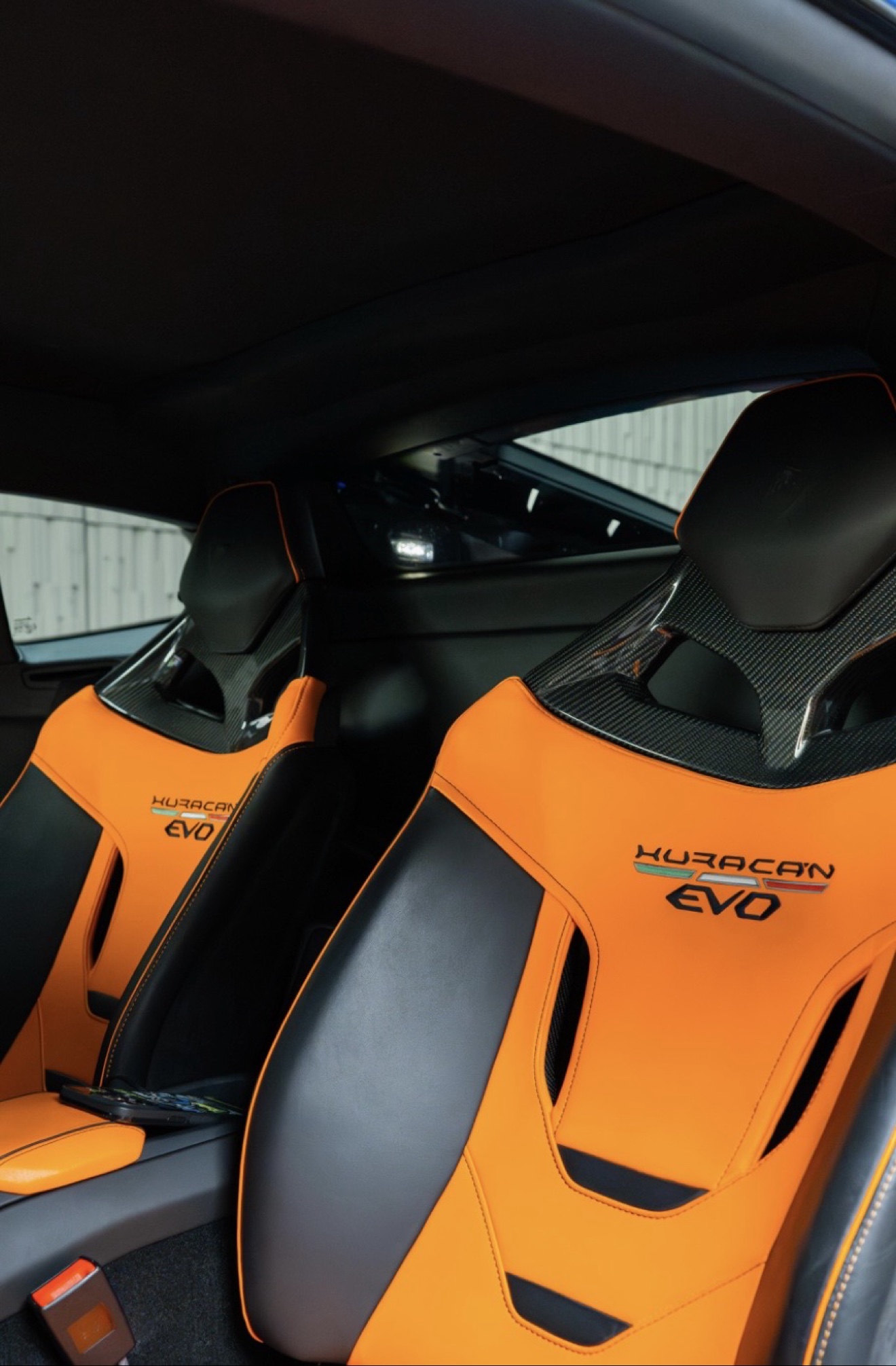 Orange and black carbon-fiber seats in the Lamborghini Huracán Evo