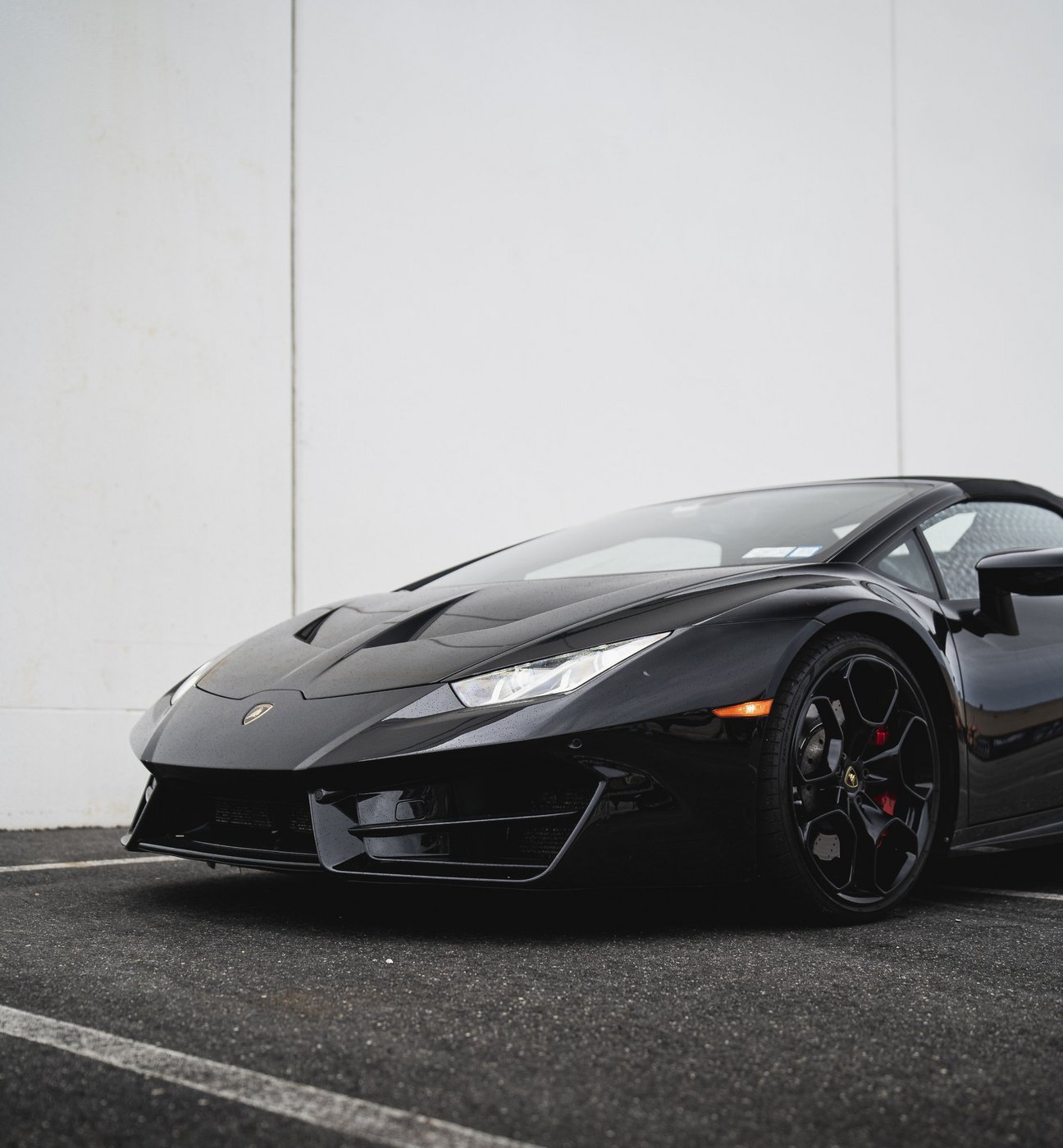 Black Lamborghini Huracán Evo Spyder shown from the front three-quarter angle