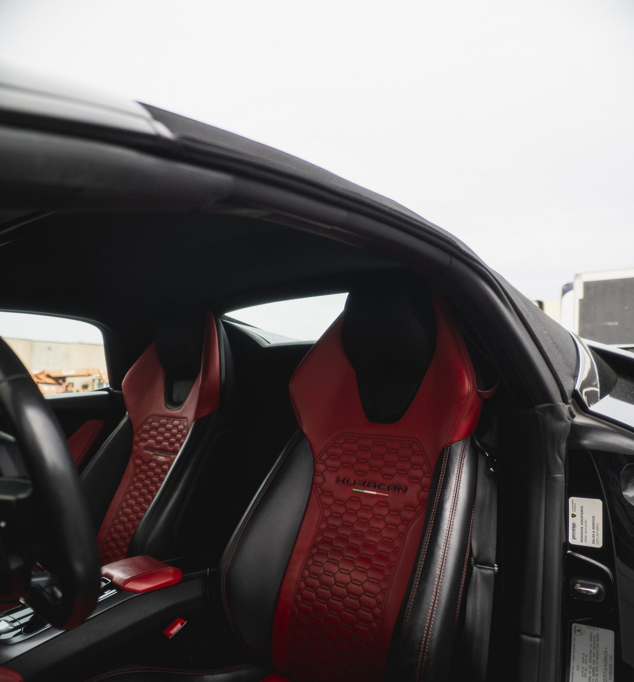 Red and black leather seats in the black Lamborghini Huracán Evo Spyder