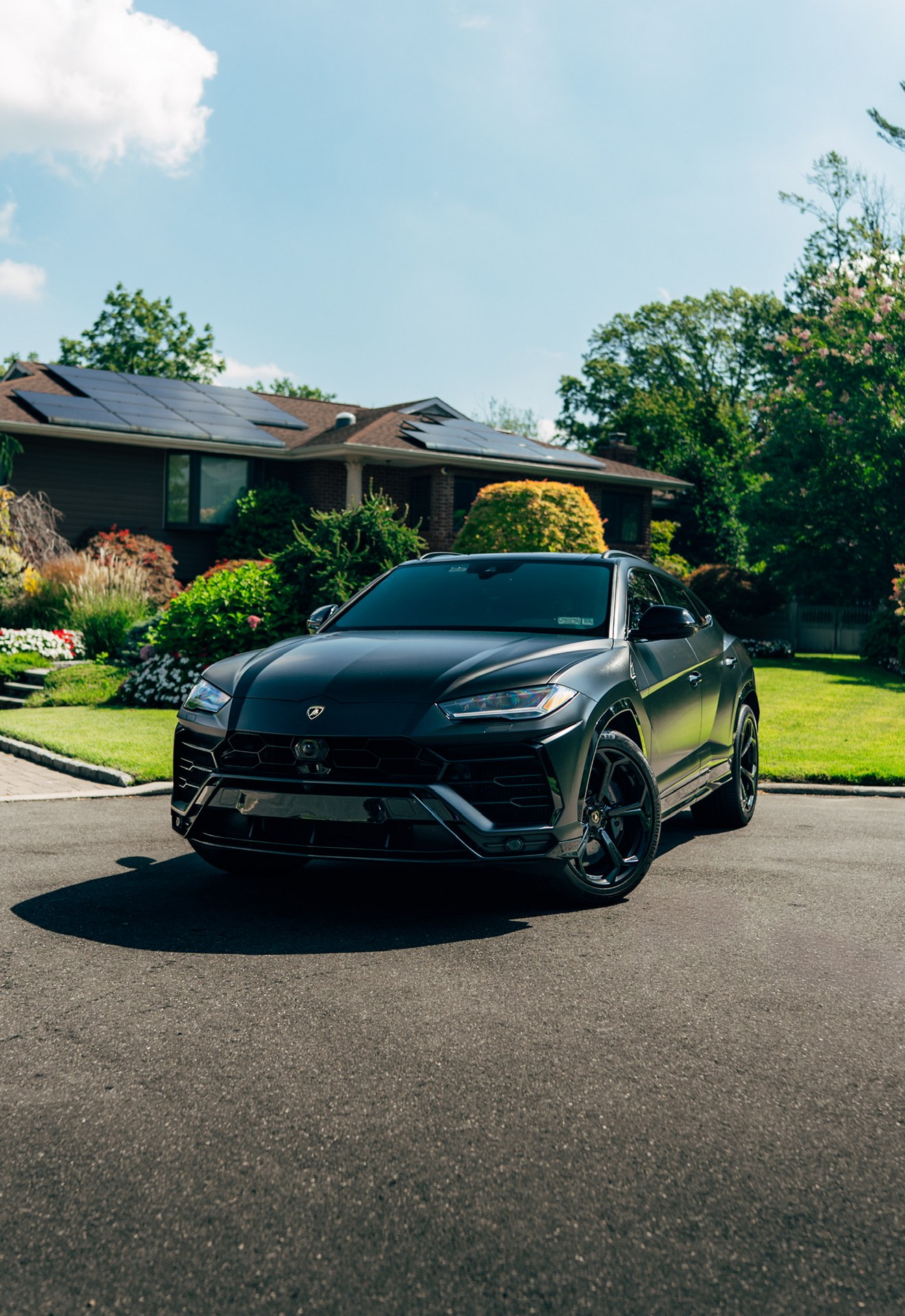 Matte black Lamborghini Urus shown from the front three-quarter angle