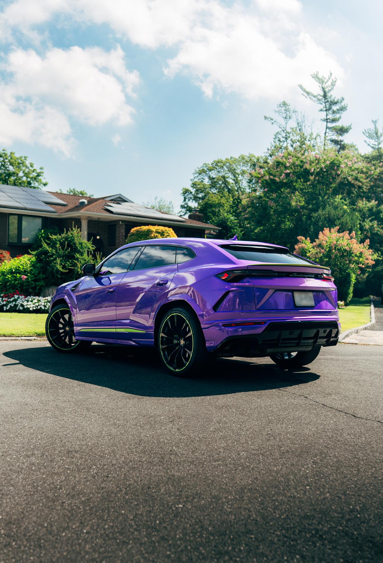 Purple Lamborghini Urus shown from the rear three-quarter angle