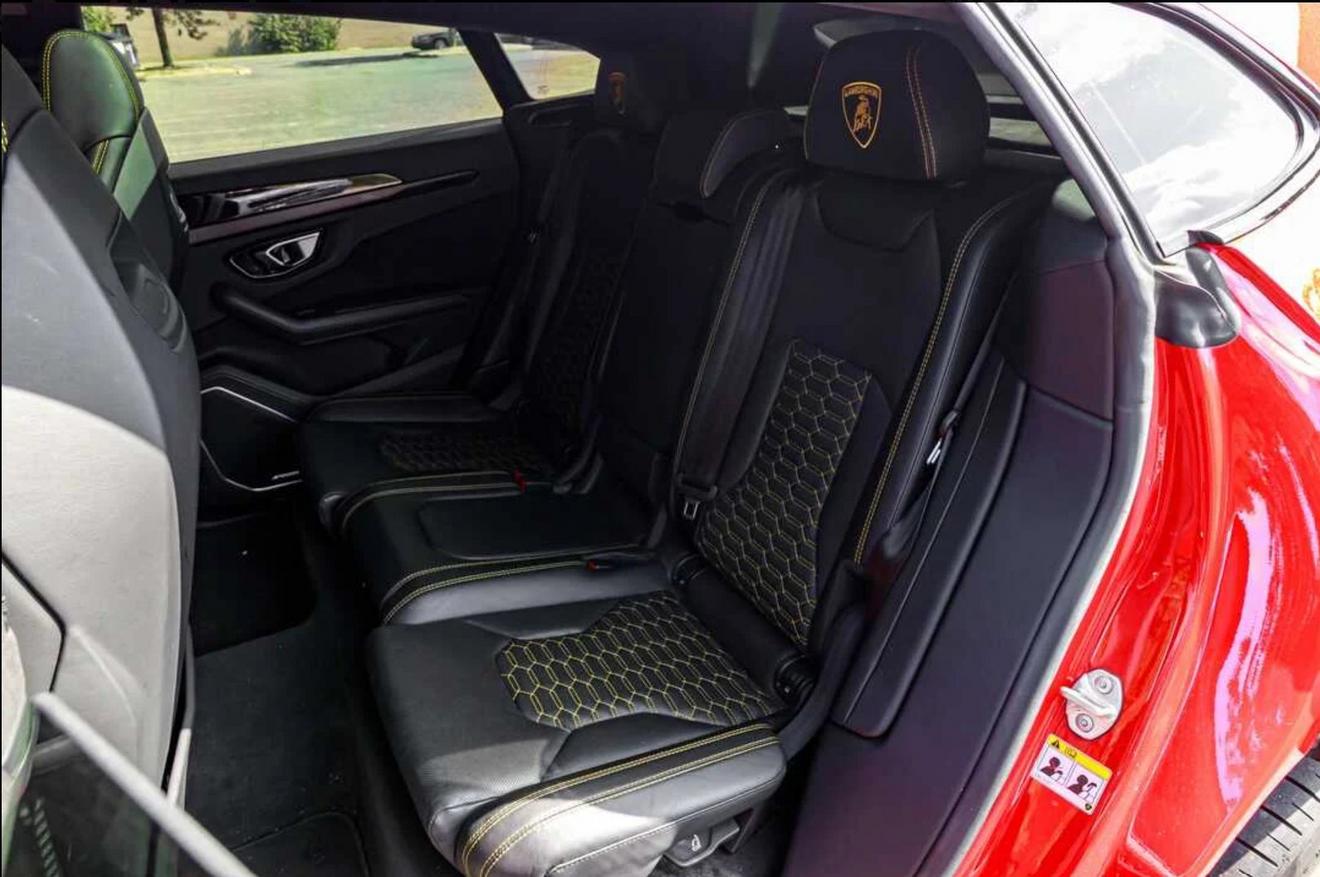Black leather rear seats with yellow stitching in the red Lamborghini Urus