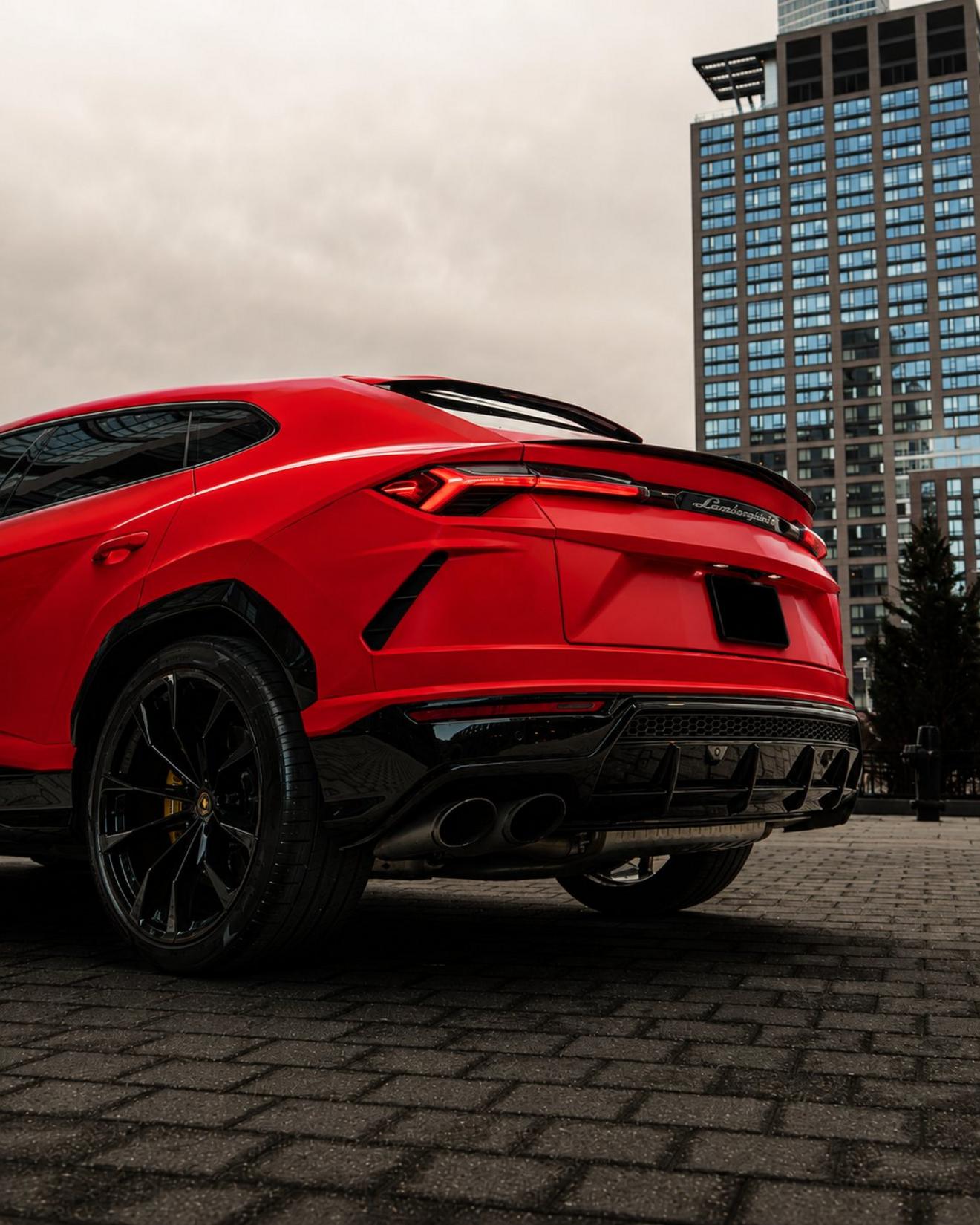 Red Lamborghini Urus shown from the rear three-quarter angle