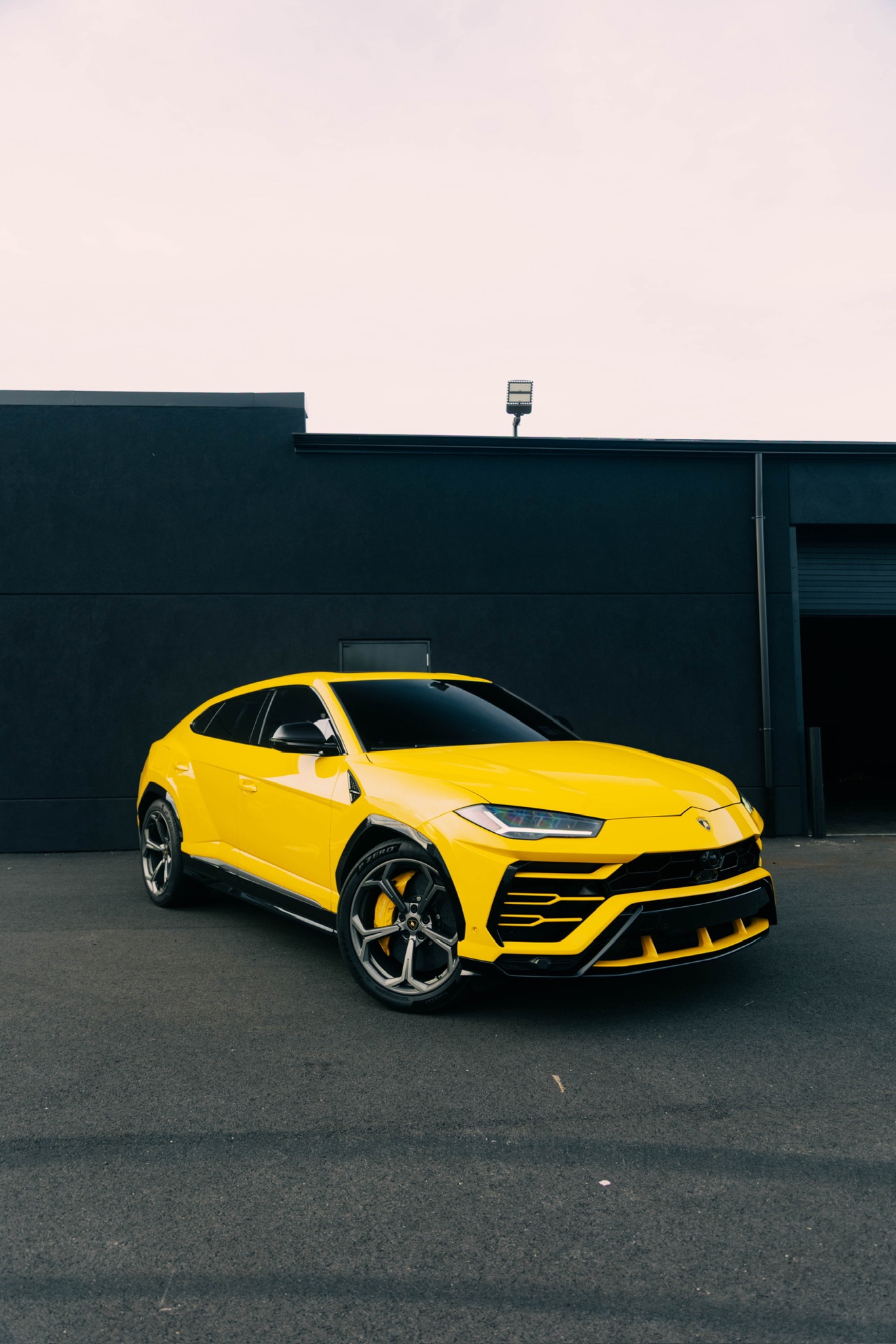 Yellow Lamborghini Urus shown from the front three-quarter angle
