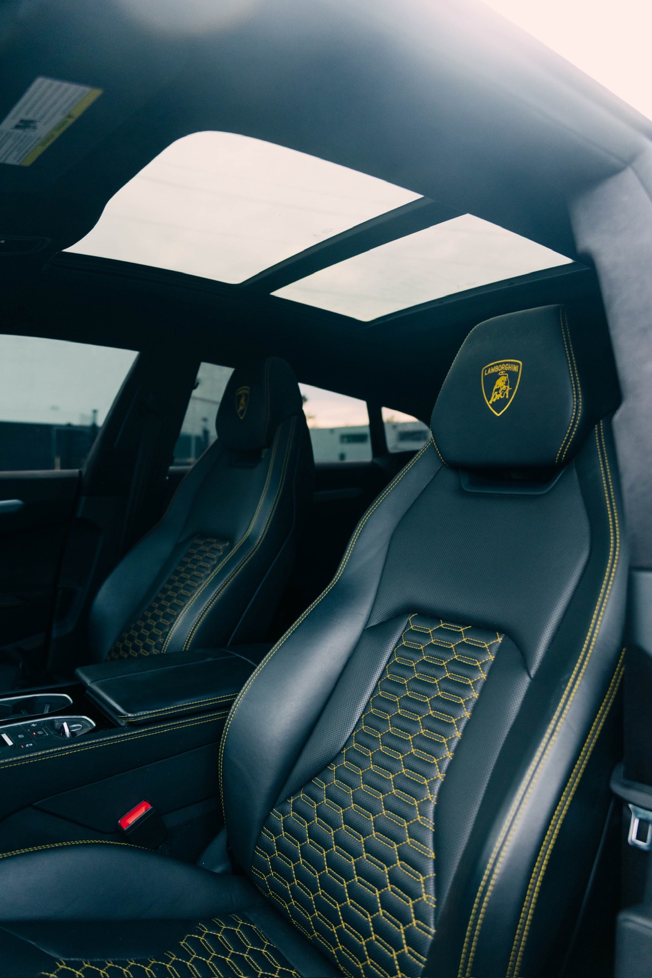 Black front seats with yellow stitching in the yellow Lamborghini Urus