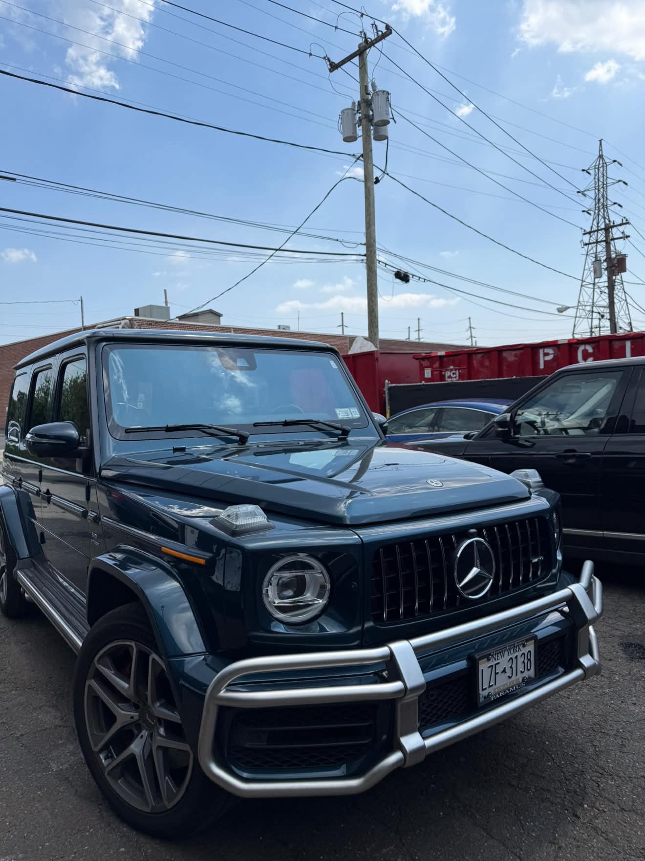 Dark blue Mercedes-AMG G63 shown from the front three-quarter angle