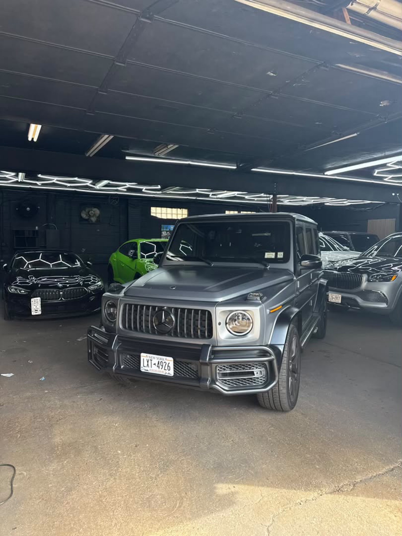 Gray Mercedes-AMG G63 shown from the front three-quarter angle